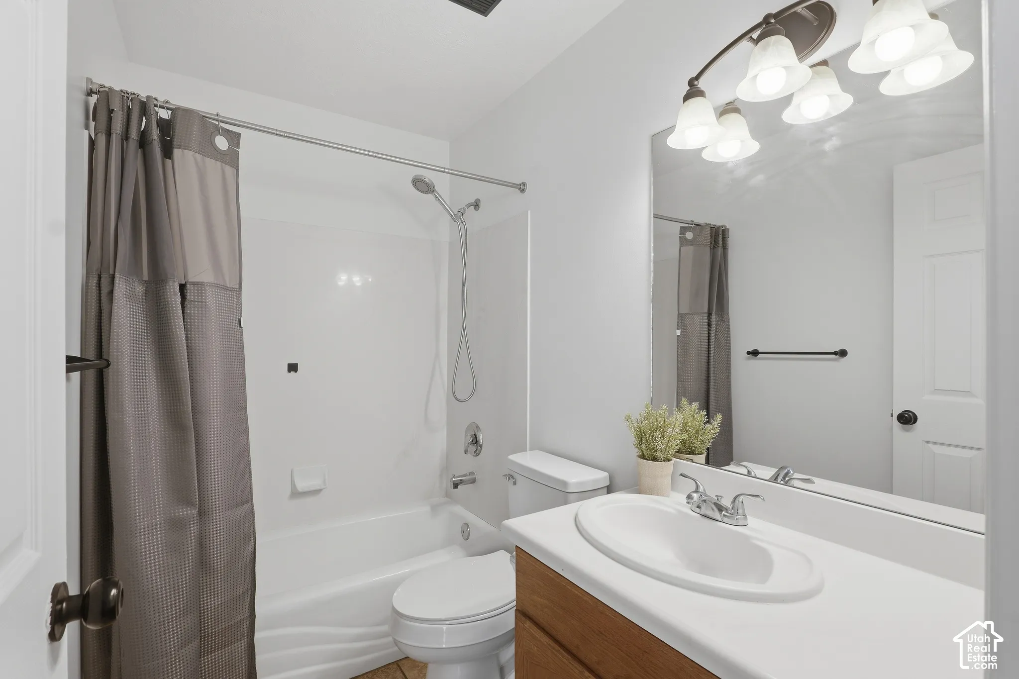 White shower/tub combination with chrome fixtures