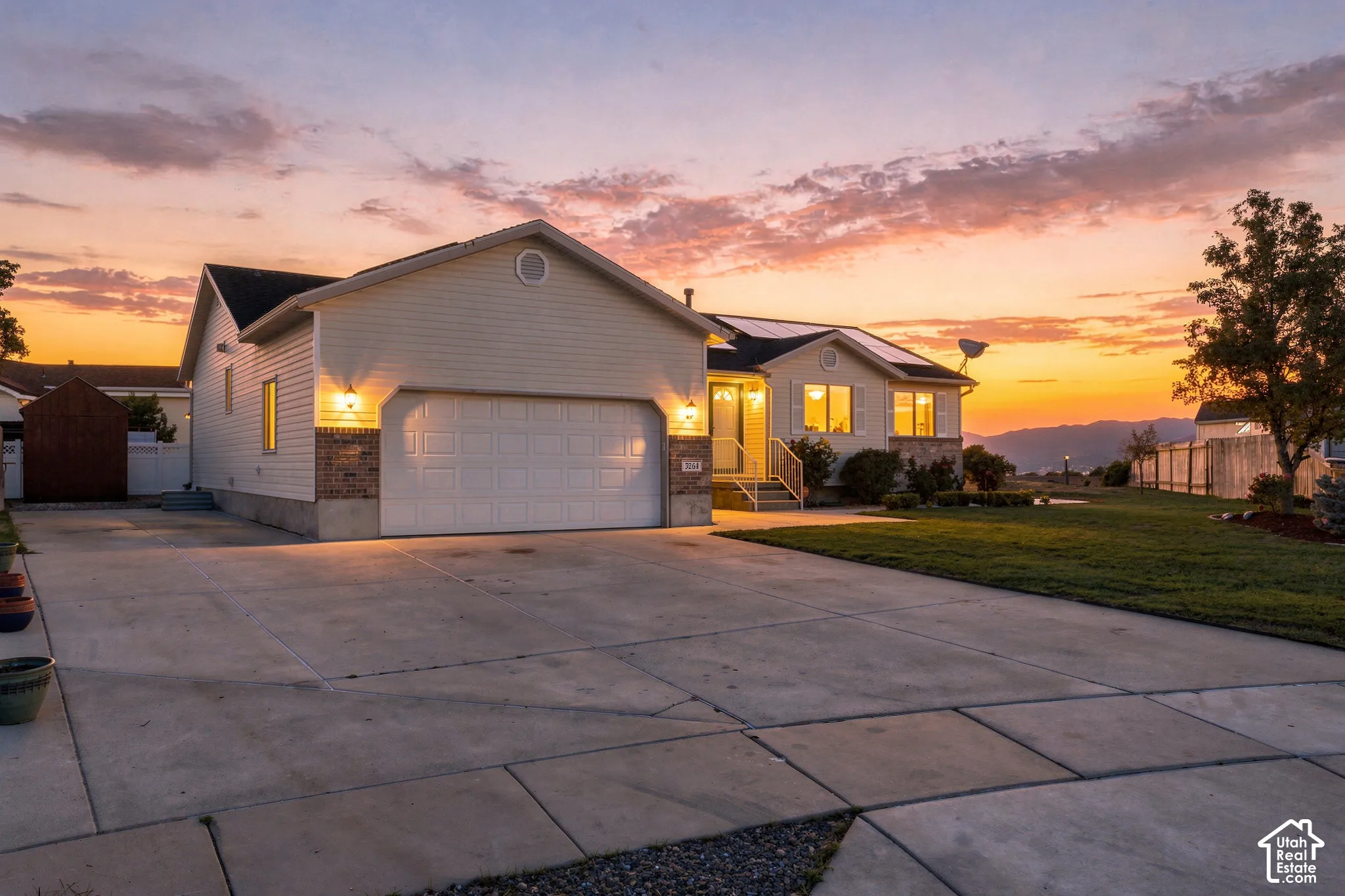 Contemporary exterior featuring light-colored siding and brick accents