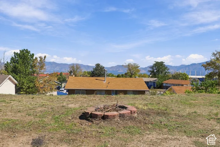 Outdoor space featuring a brick-lined fire pit