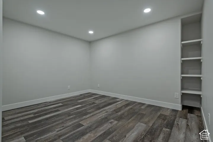Wood-finish flooring, recessed lighting, and built-in shelving