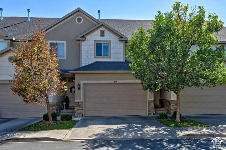 Stucco and shake siding exterior with stone accents