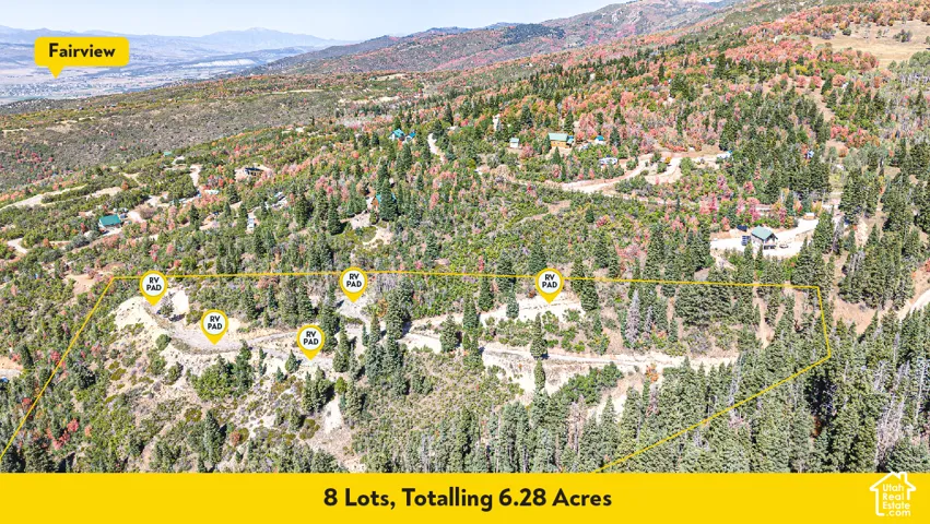Expansive 6.28-acre parcel containing eight individual lots featuring mature timber, mountain terrain, and established gravel pads for recreational vehicles