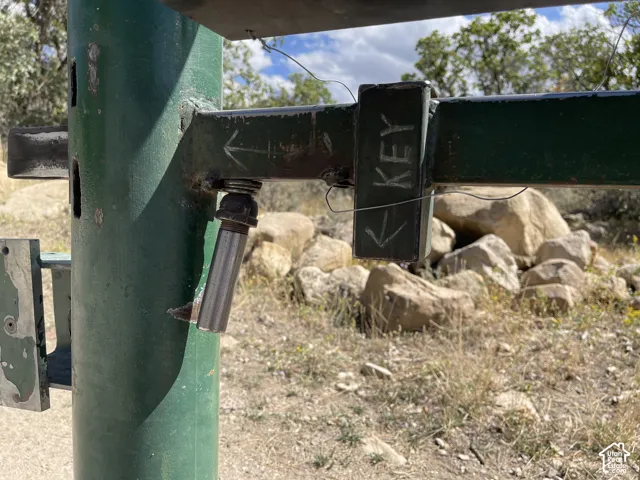 The lock is inside that rectangular box labeled "KEY". Once it is unlocked, slide the silver handle to the right and push gate open.