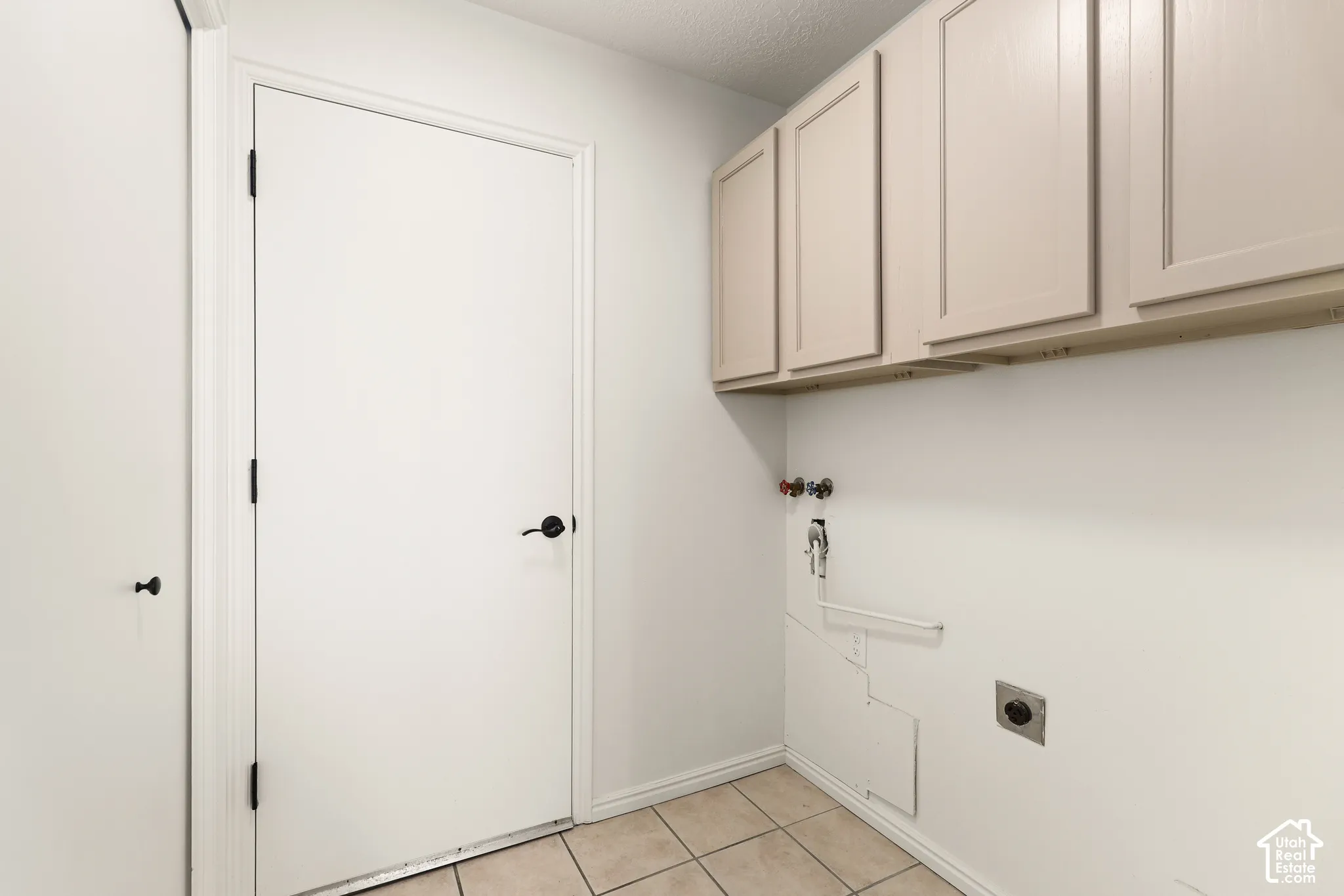 Built-in cabinetry, tile flooring, and utility hookups