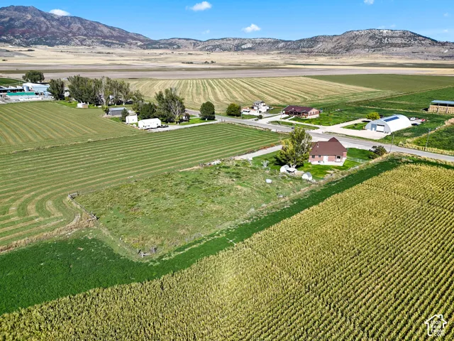 Expansive agricultural landscape with cultivated fields and distant mountain ranges