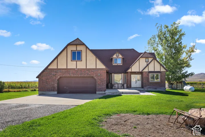 Brick and stucco exterior with a dark shingle roof