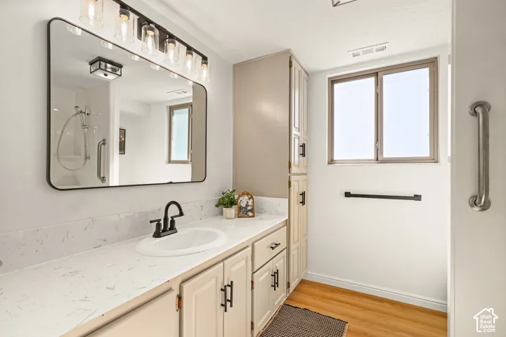 Vanity with integrated sink, matte black faucet, and light-toned countertop