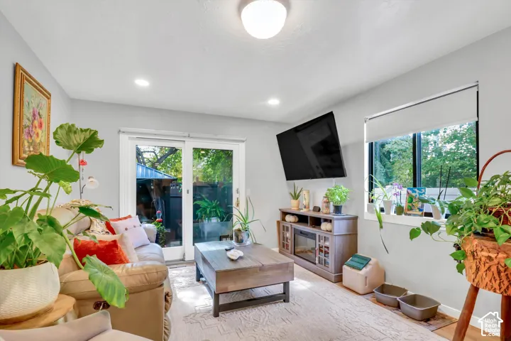 Recessed lighting, sliding glass door, overhead light fixture, large window, wood-finish flooring