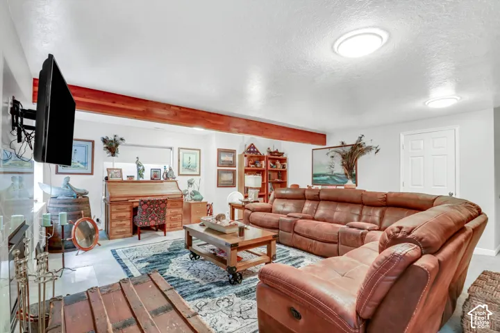 Recessed lighting fixtures illuminate the space, complemented by exposed wood beams