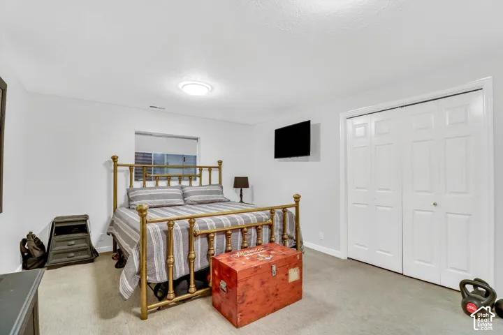 Recessed window, ceiling-mounted light fixture, wall-mounted television, and bi-fold closet doors