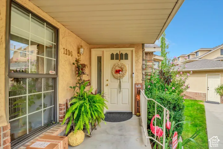 Covered entryway and the man door to detached garage on the right of photo