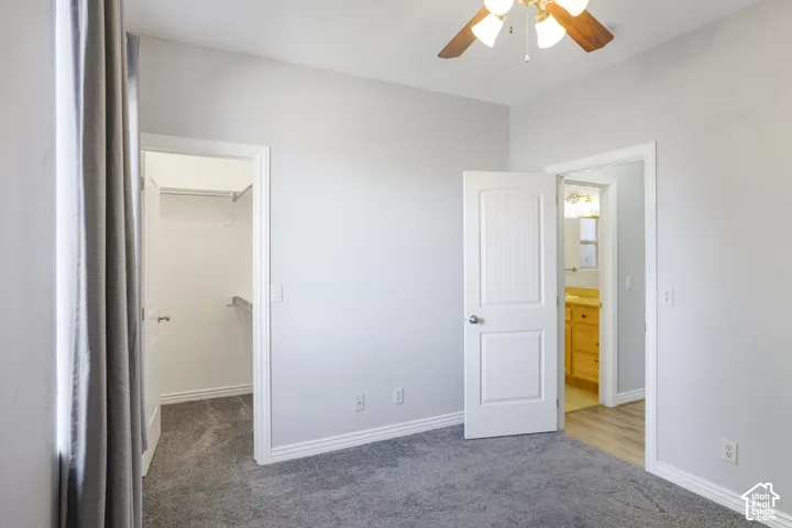 Recessed lighting, ceiling fan with wood-finish blades, soft gray wall paint, gray carpet, and white trim throughout