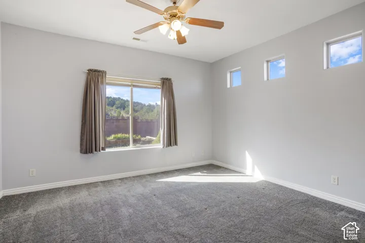 Recessed lighting, ceiling fan, multiple windows, and light gray wall paint