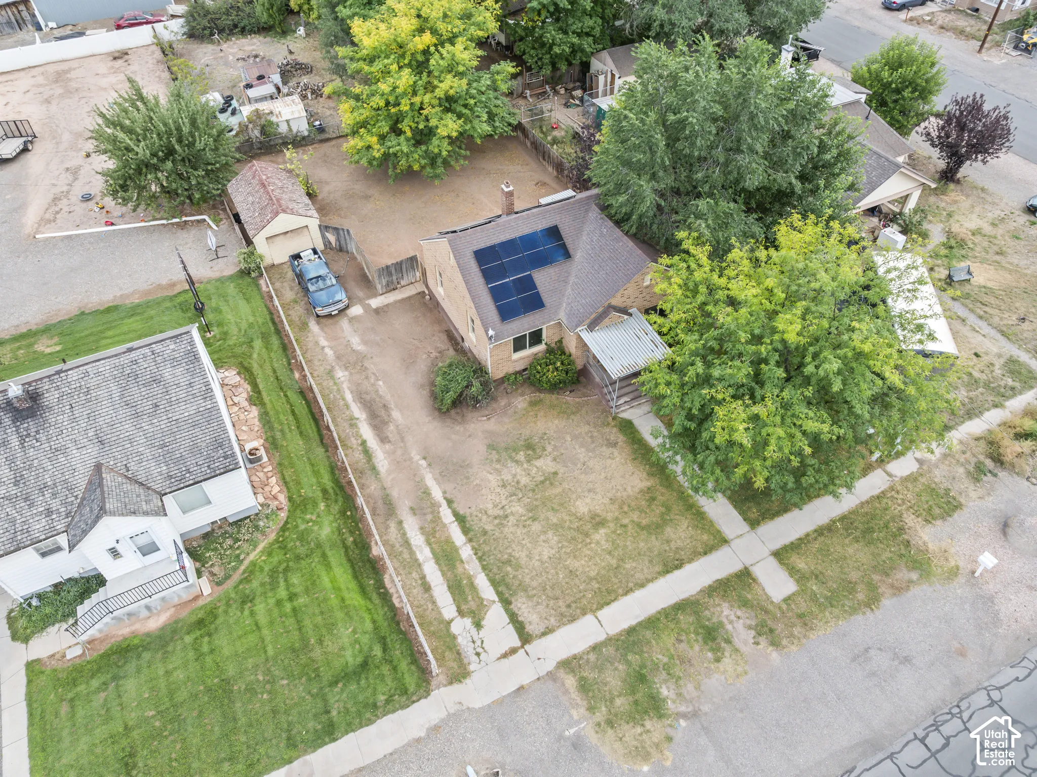 Single-story residence featuring a gabled roof with solar panels