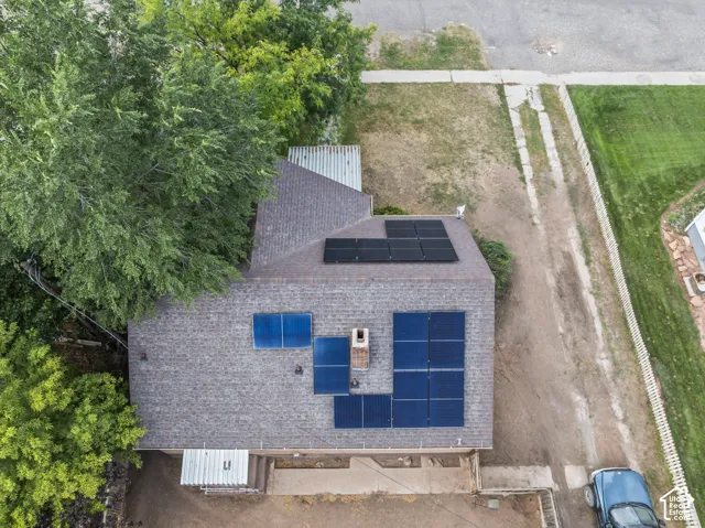 Brown shingle roof with multiple solar panel arrays