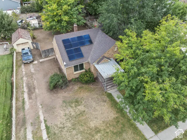 Brick exterior with solar panels and a covered entry