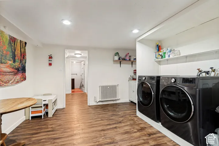 Recessed lighting, wood-finish flooring, and white walls throughout