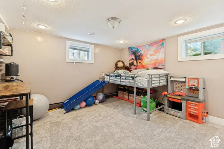 Recessed ceiling lighting, two windows with white trim, wall-to-wall carpeting, and a semi-flush mount ceiling light fixture