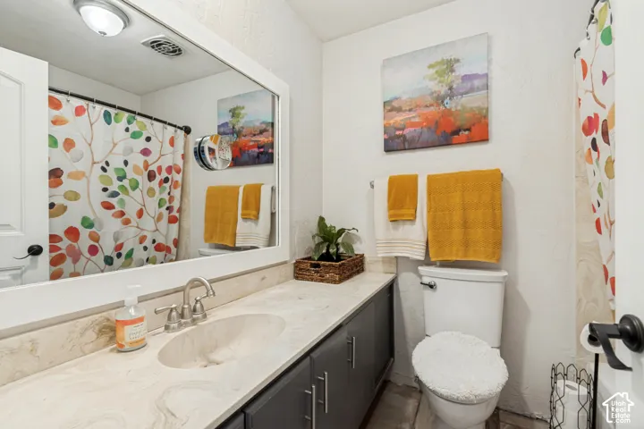 Spacious vanity with a built-in sink, brushed nickel faucet, and undermount cabinetry