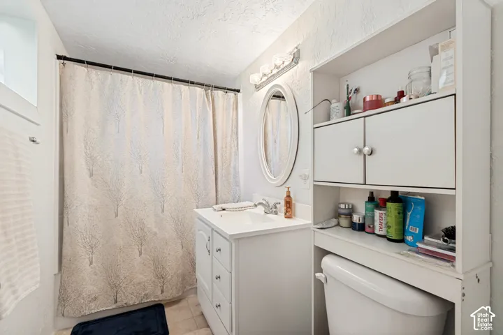 White vanity with integrated sink and chrome faucet