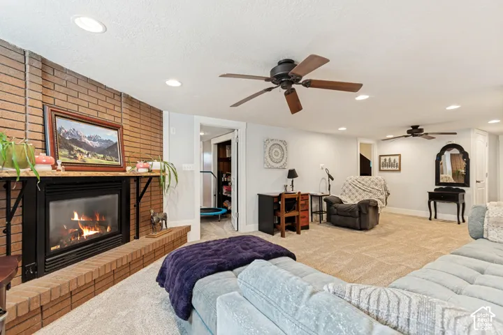 Brick fireplace with a black firebox and a wood mantel