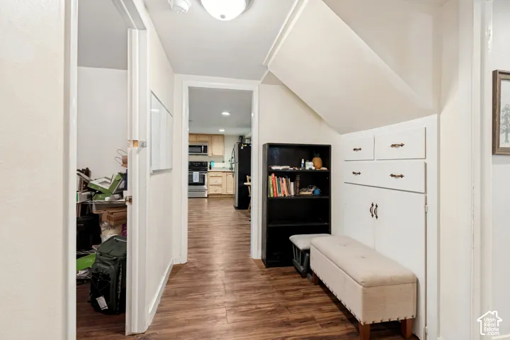 Wood-finish flooring throughout, built-in cabinetry with drawer and cabinet storage, overhead flush-mount lighting