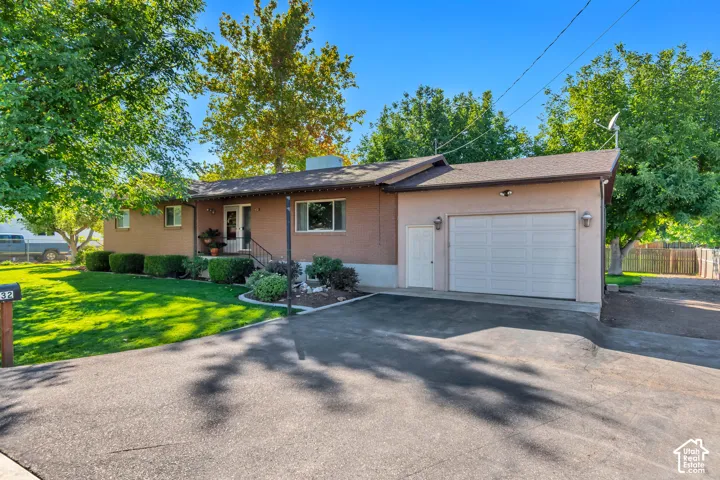 Paved driveway leading to an attached garage with a side door entry
