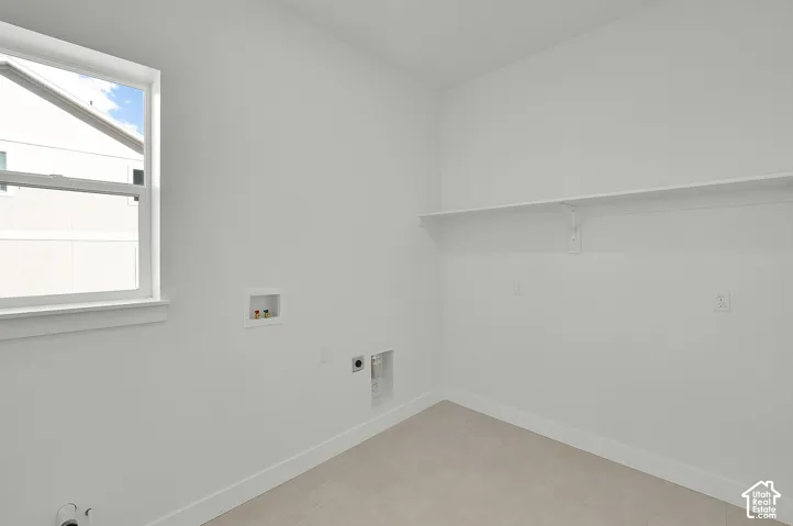 White walls with a window, single shelf, and tile flooring