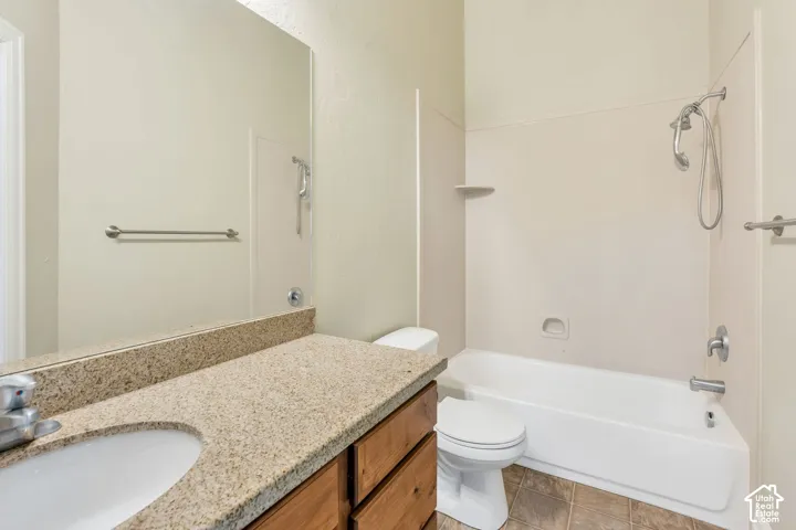 2nd level Bathroom featuring a spacious vanity with an undermount sink, a large mirror, a combination shower/tub, and a toilet