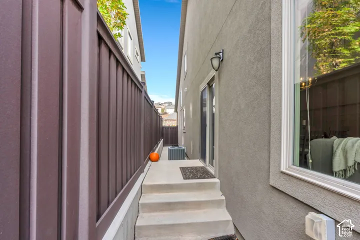 Sliding glass doors off the kitchen provide easy access to the beautiful backyard, with steps leading down to the outdoor space, perfect for entertaining, relaxing, and enjoying the outdoors.