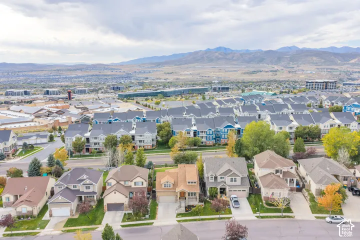 Residential neighborhood featuring single-family homes and multi-story dwellings, with distant mountains defining the horizon