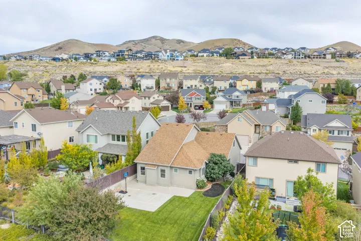 Expansive residential area featuring numerous single-family homes, mature landscaping, and mountainous terrain