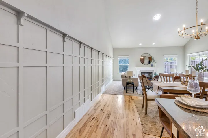 Wood-finish flooring leading to a living area with a vaulted ceiling