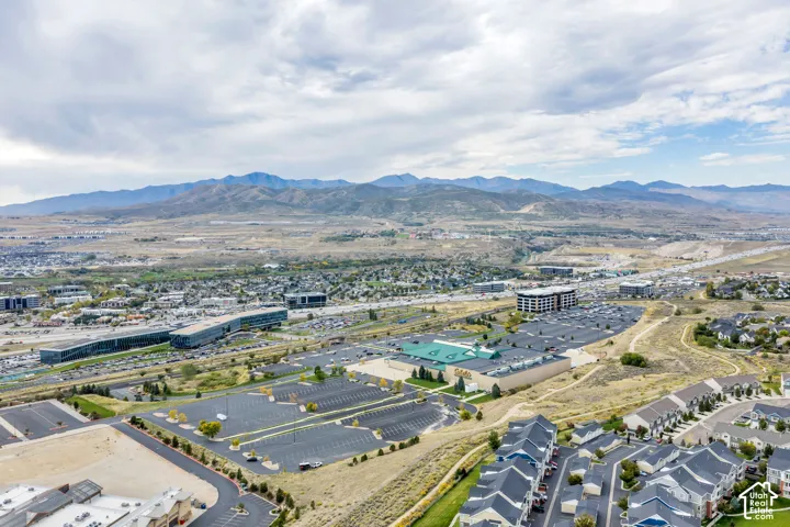 Expansive mountain backdrop with a surrounding urban landscape and residential developments