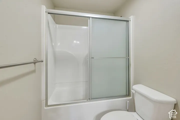 2nd level Bathroom featuring a spacious vanity with an undermount sink, a large mirror, a combination shower/tub, and a toilet