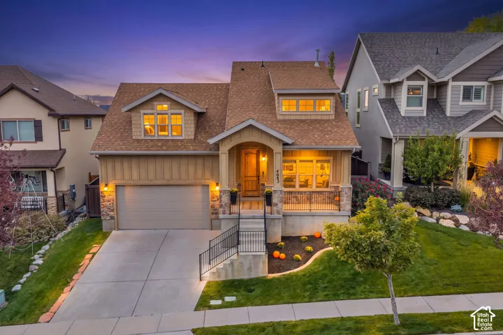 Craftsman-style 2 story HOME with stone accents, covered front porch, attached garage, dormer windows, and mature trees.