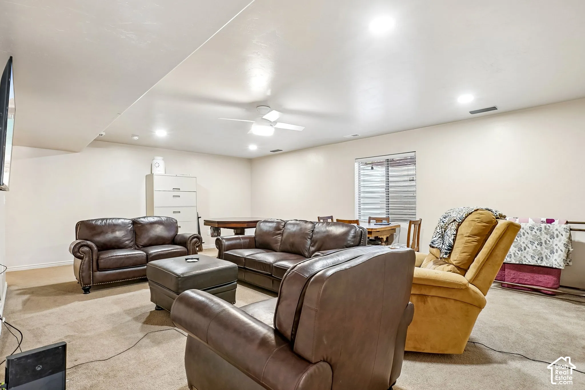 Recessed ceiling lighting, ceiling fan, and carpeted flooring