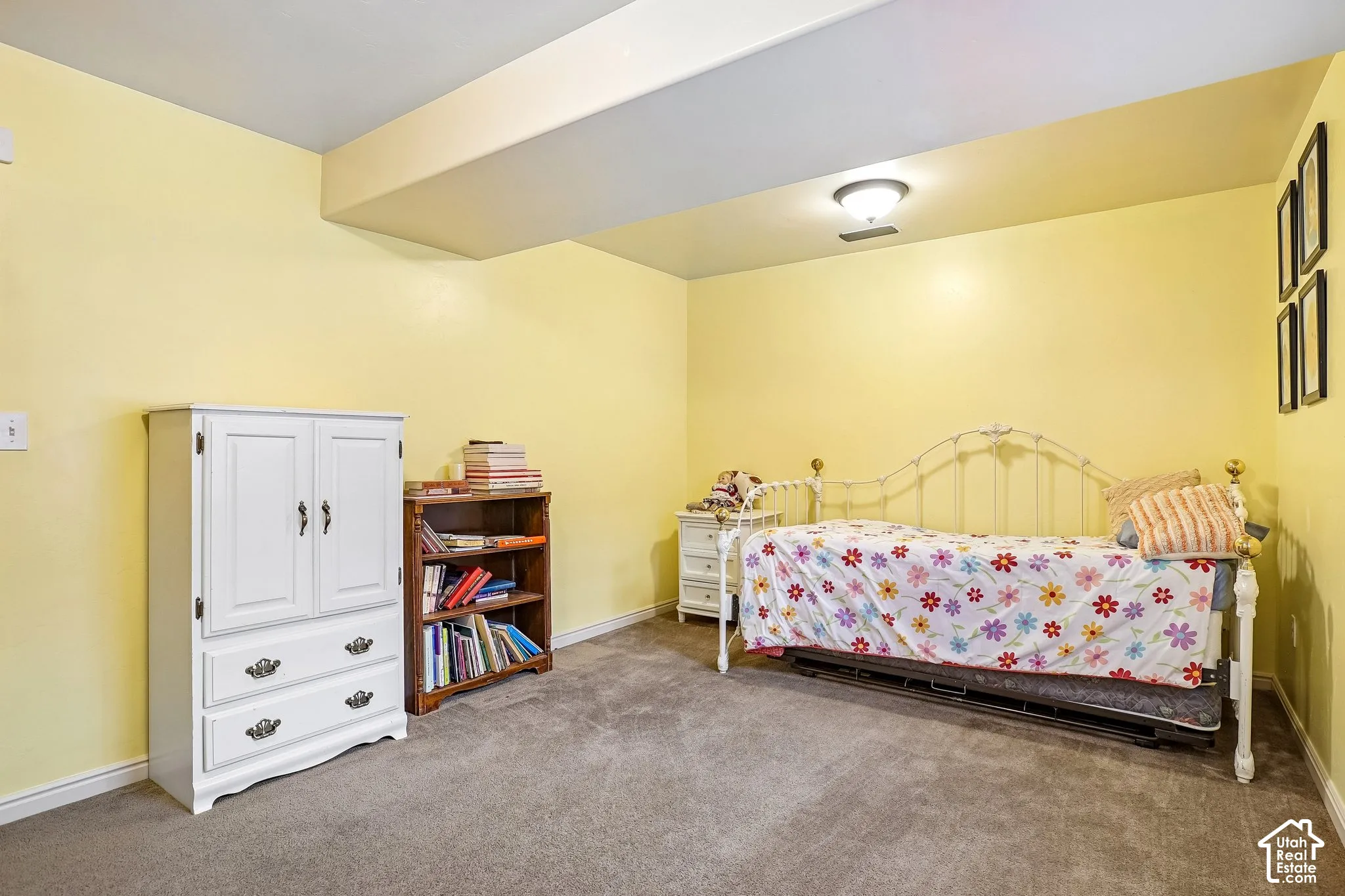 Carpeted flooring with light-toned walls and a flush-mount ceiling light