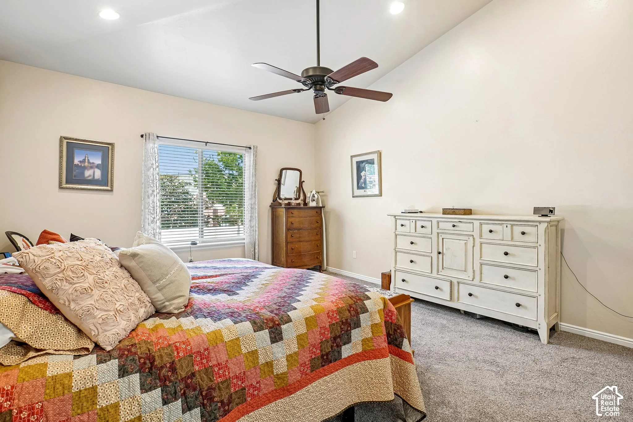Vaulted ceiling with a ceiling fan, recessed lighting, carpet flooring, and a large window