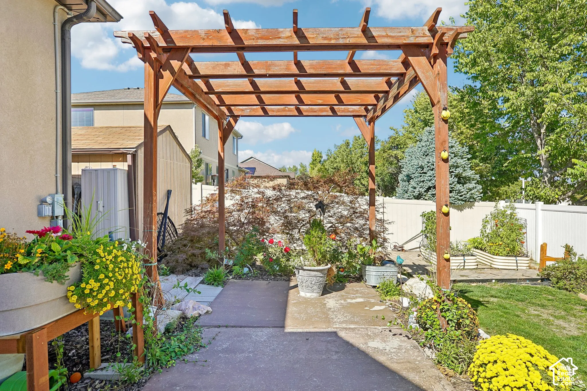 Wood pergola over a patio area with concrete pavers