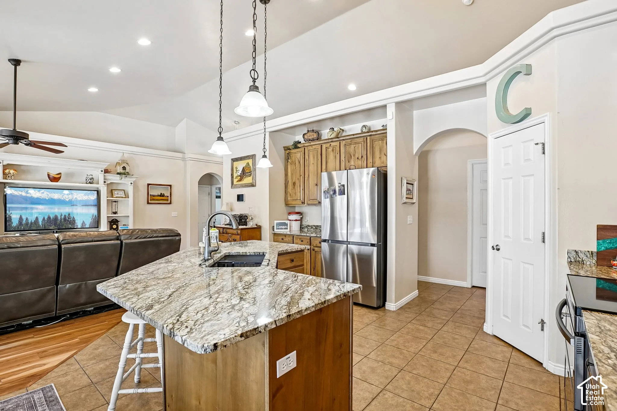 Kitchen island with an undermount sink and pendant lighting