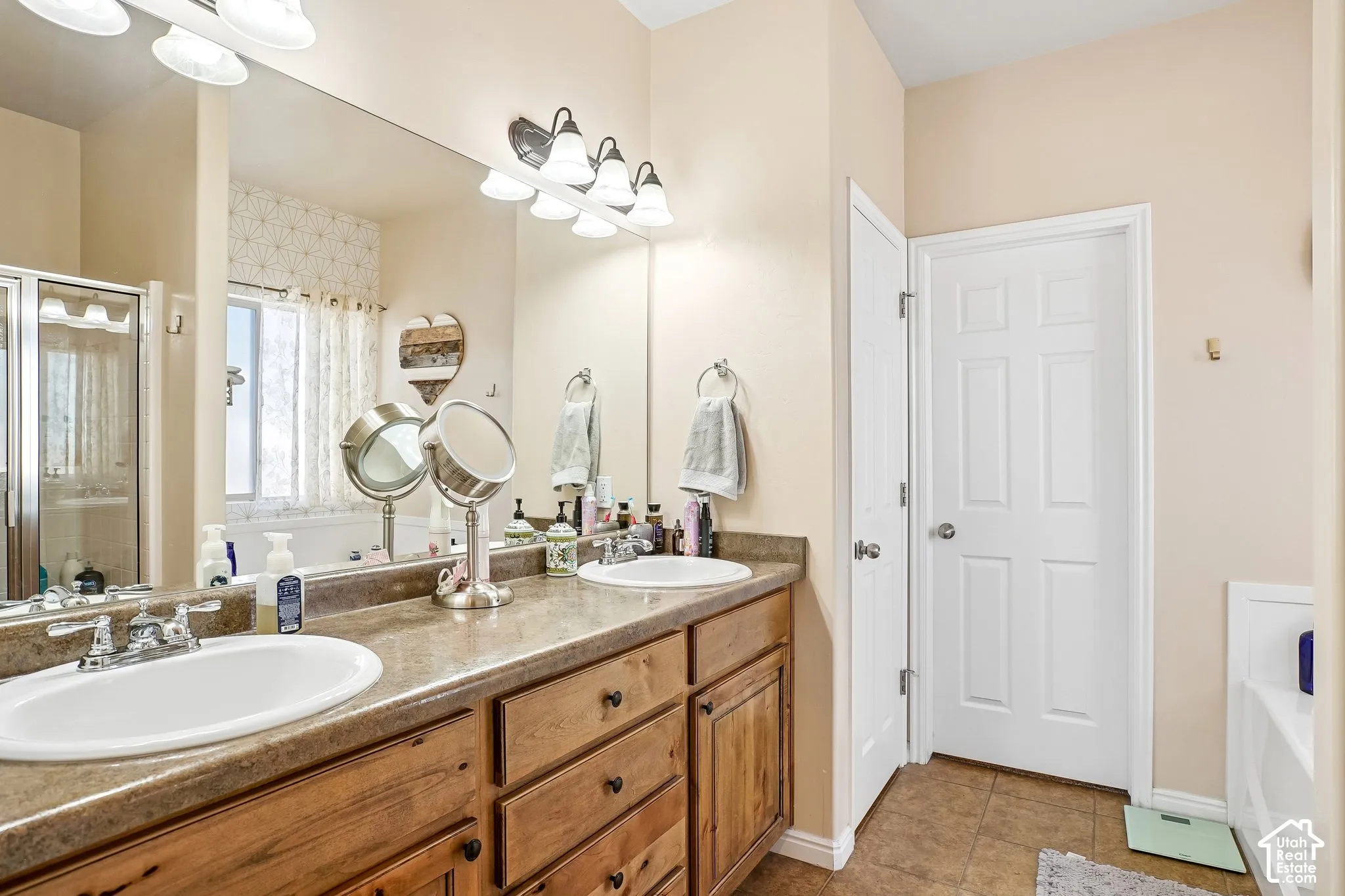 Dual undermount sinks set in a wood-finish vanity with a stone-look countertop