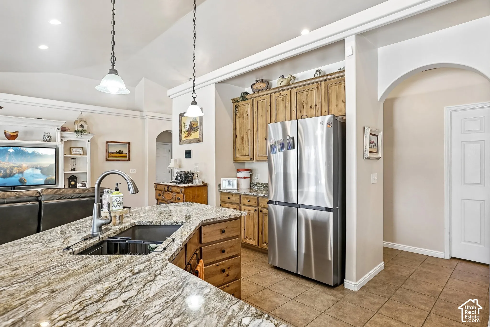 Kitchen island with a built-in sink and an arched faucet