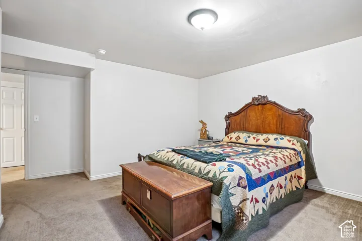 Wall-to-wall carpeting with light-colored walls and a classic wood door