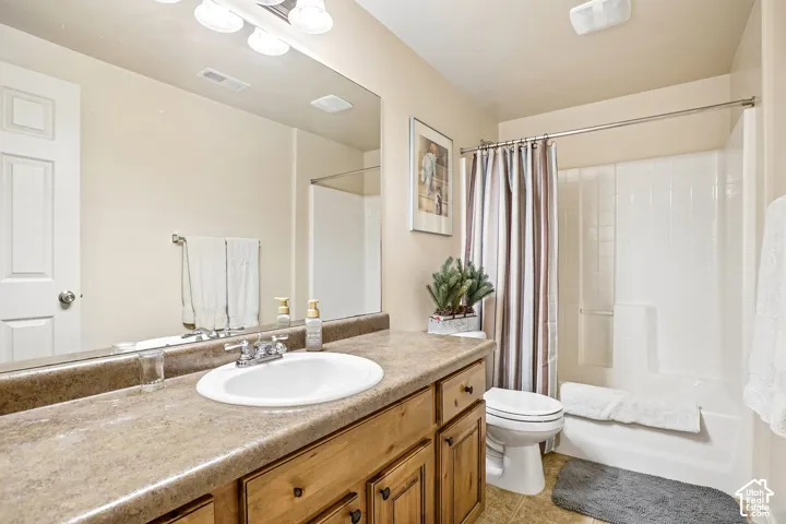 Vanity with an integrated white sink, wood-finish cabinetry, and a chrome faucet