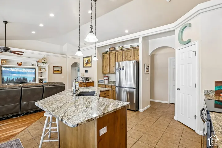 Kitchen island with an undermount sink and pendant lighting