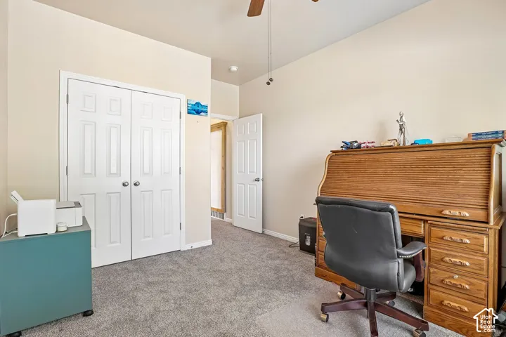 Carpeted flooring, vaulted ceiling, white paneled doors, and neutral wall paint