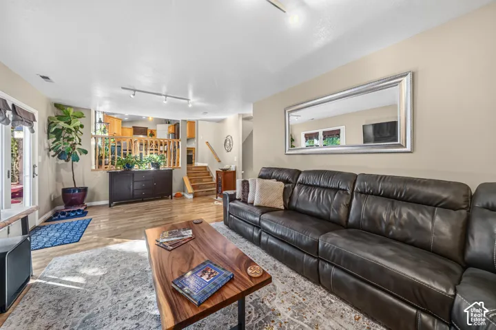 Hardwood-finish flooring, recessed lighting, and track lighting fixtures