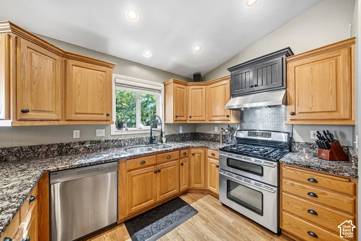 Wood-finish flooring, recessed lighting, and granite countertops
