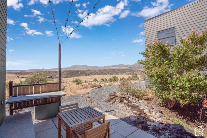 Patio space with concrete pavers, gravel landscaping, and a built-in outdoor counter
